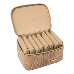 Travel jewelry organizer by Marcy McKenna with beige snakeskin. Shown with eight individual zipper pouches neatly filed inside.